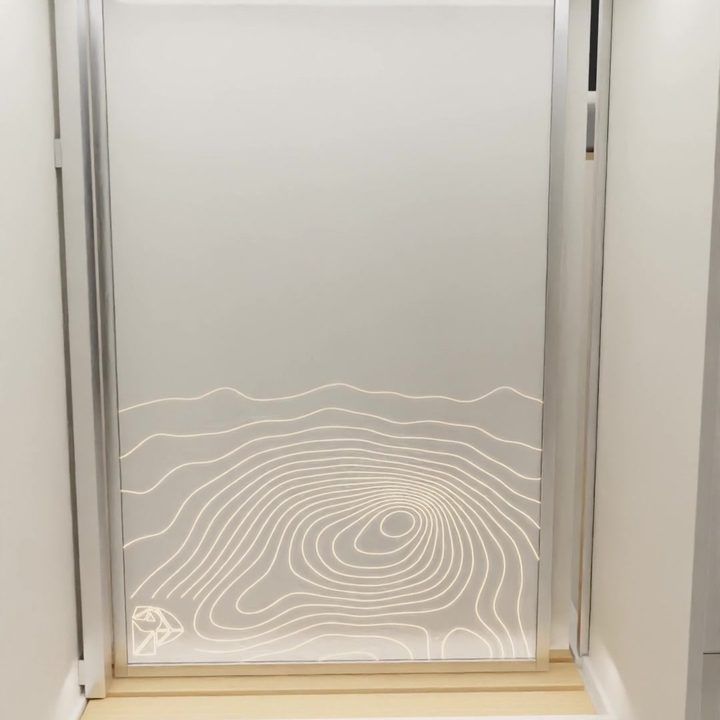 Instagram: the contour-lit shower screen through the open bathroom door